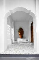 Imposing, white-painted hallway with terrazzo floor