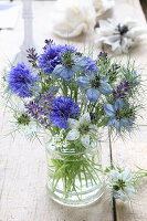 Small bouquet of flowers in blue and white with lavender, cornflowers and maiden in the green