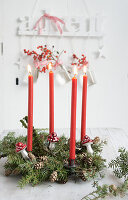Advent wreath made from hemlock with red candles