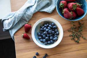 Fresh strawberries and blueberries in bowls