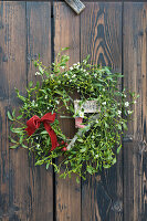 Wreath made of mistletoe with velvet ribbon