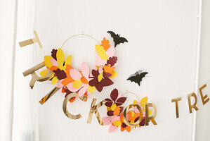 Trick or treat wall decoration with paper leaves and bats for Halloween