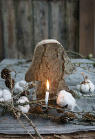 Mushroom cut out of bark, with cotton, candle, larch twigs, and cones