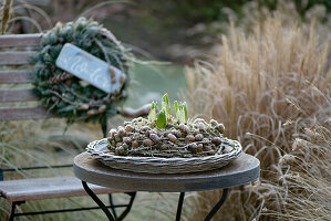 A wreath made of larch branches and cones, covered with hoarfrost