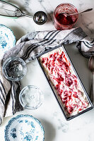 Ice cream dessert with summer berry puree in a loaf tin