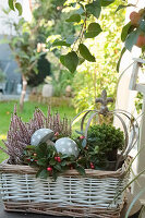 Autumn decoration in a basket with mushrooms made of concrete, heather (erica) and American wintergreen