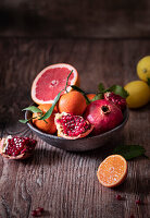 Plate of fresh pomegranates and citrus fruit