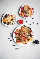 Folded crepes with berries and chocolate icing