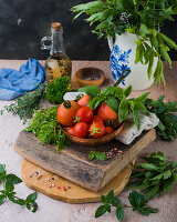 Still life with fresh herbs and tomatoes