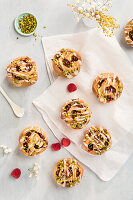 Yeast buns with raspberry jam and pistachios