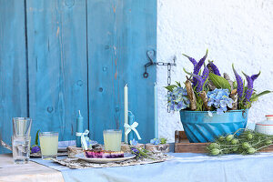 Vintage gugelhupfform with veronica, hydrangea, and birch twigs on set table with cake and drink