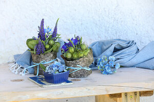 Decoration with veronica, love-in-a-mist in the green and hydrangea in a birch pot