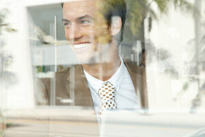 A young businessman behind a window