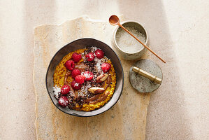 Golden Porridge with almond drink and raspberries