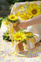 Sunflower in a paper cup as a gift for guests