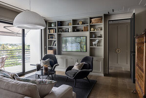 Traditional living room with shelving and television