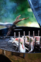 Fish being smoked over indirect heat