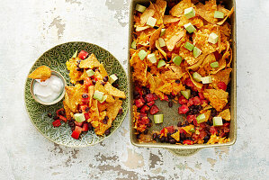 Quick vegan nacho bake with black beans, tomatoes and avocado