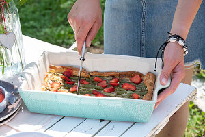 Asparagus quiche with strawberries for a summer party in the garden