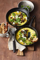 Skillet of baked sweet corn, creamed corn, mushrooms and feta warm from the oven