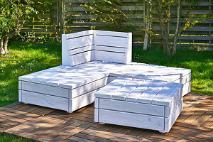 DIY lounge bench and table made from building boards in the garden