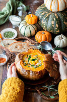 Kürbissuppe mit Salbei im Kürbis serviert