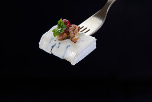 Blue cheese with walnut on fork