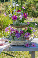 Flower etagere with ornamental baskets, gladioli and showy bindweed