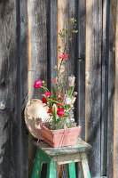 Glasfläschchen mit Frühlingsblüten im Übertopf, Frühlingsdeko