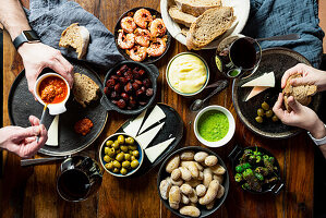 Tapas buffet with papas arrugadas, mojo, Padrón peppers, prawns, and chorizo