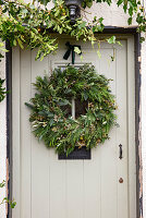 Christmas door wreath with fir branches on a front door