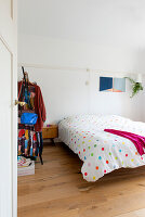 Bedroom with polka dot bed linen and wall decoration