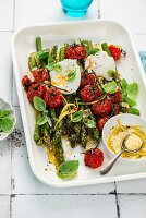 Asparagus with tomatoes, lemon mustard dressing and poached eggs