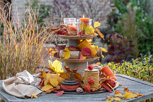 Autumnally decorated etagere on garden table