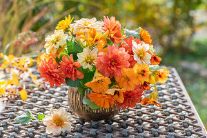 Bouquet on patio table, dahlias (Dahlia), marigold (Calendula) and nasturtium (Tropaeolum), autumn atmosphere