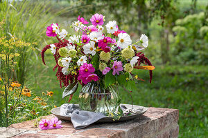 Bouquet of coneflower 'Delicous Nougat' (Echinacea), cosmea (Cosmos), foxtail (Amaranthus), roses 'Double Delight' (Rosa), broccoli on garden wall