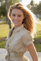 Blonde woman in light blouse dress outside