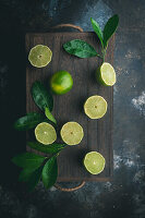 Limes with leaves on a dark background