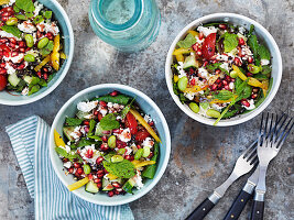 Quinoa salad with feta, mint, soybeans, bell pepper, cucumber, and pomegranate seeds