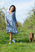 Brunette woman with dog in the garden