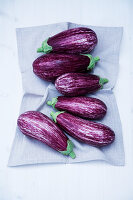 Fresh eggplant on cloth