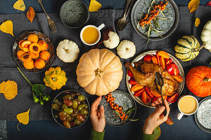 Roast turkey, pumpkins, vegetable salad, fruit and orange drink for Thanksgiving