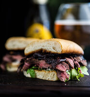 Steak sandwich with red onion marmalade, arugula and horseradish aioli on toasted ciabatta