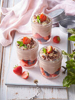 Chocolate quark dessert in a glass with fresh berries