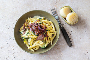 Pasta mit Zucchini, roten Röstzwiebeln und Käsesauce mit Harzer Käse (vegetarisch)