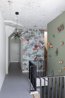 Hallway with graphic wallpaper and colorful butterfly decoration