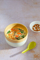 Asian vegetable soup with coconut and sesame seeds