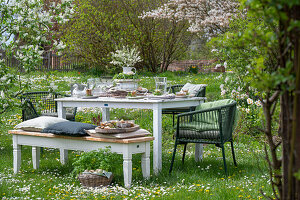 Set table in the garden for Easter breakfast in the meadow