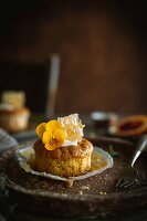 Cupcake with cream, honeycomb and pansy blossom