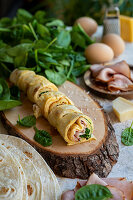 Breakfast tortilla wrap with ham, eggs and cheese
